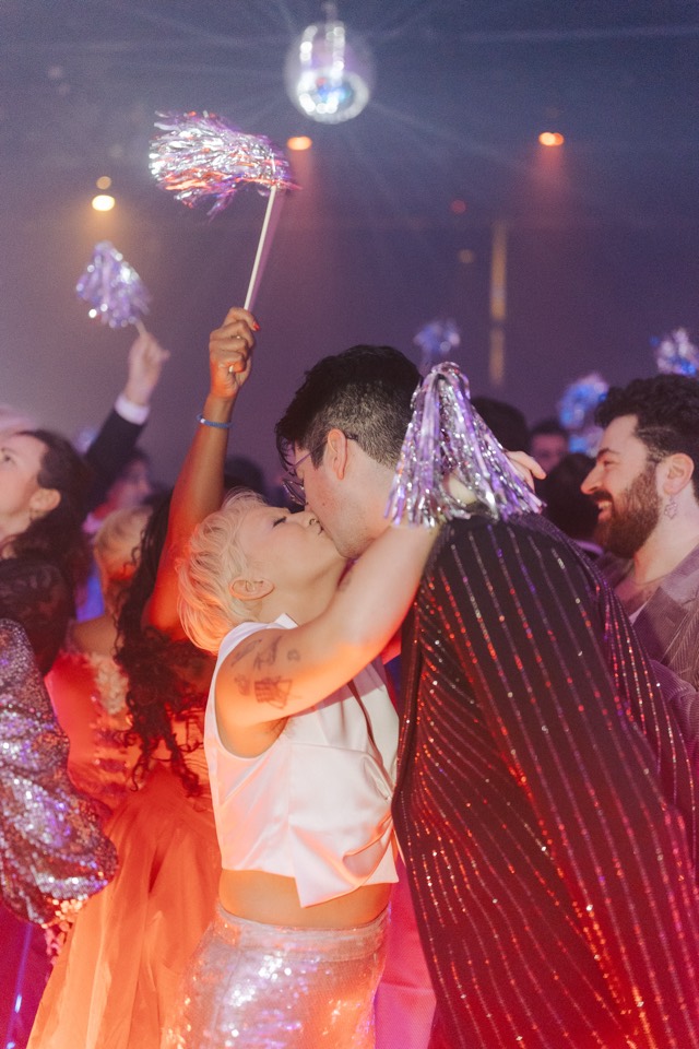 Couple kissing under sparklers on the dance floor